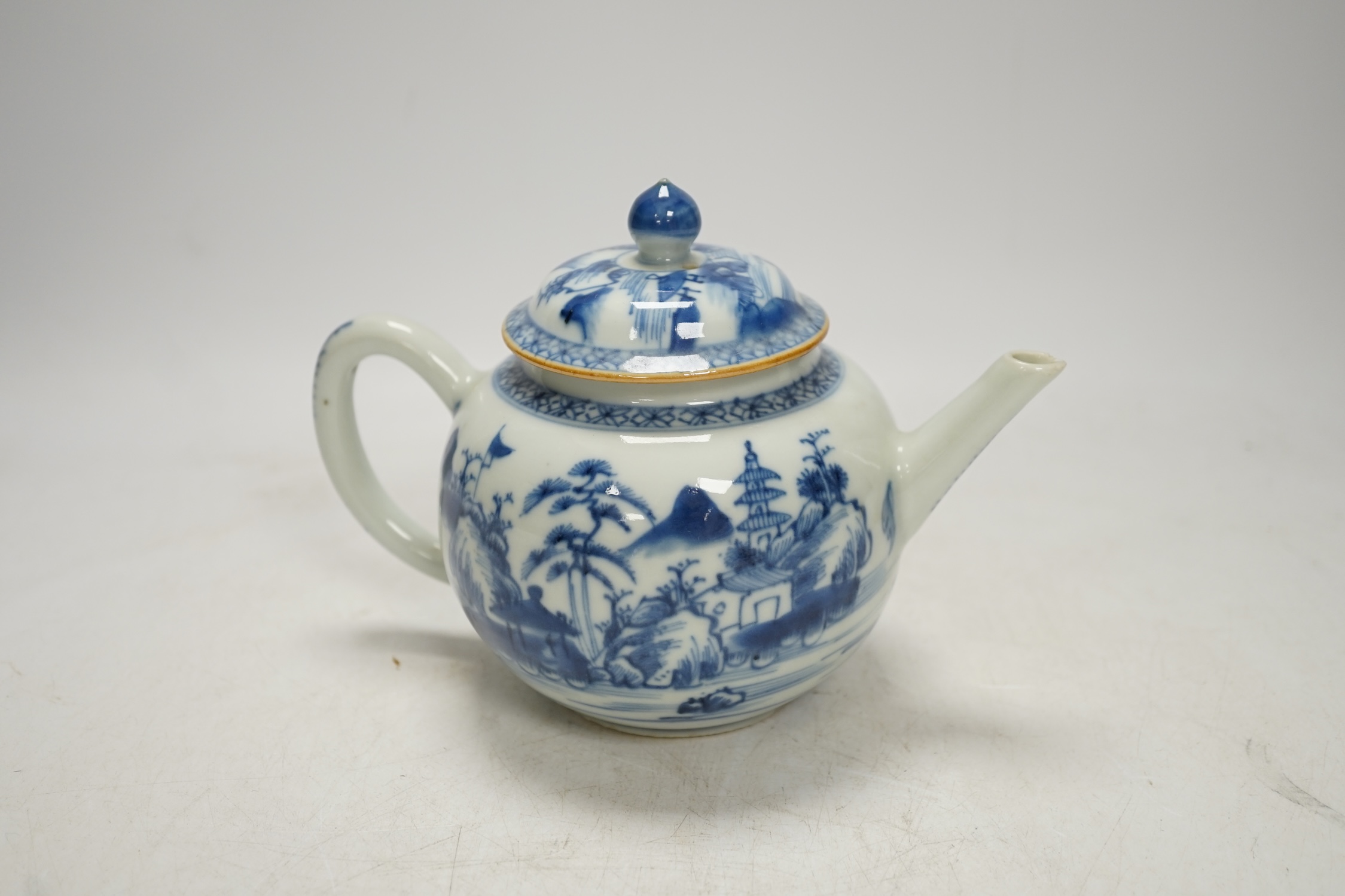 An 18th century Chinese blue and white teapot and cover, 12cm high. Condition - poor